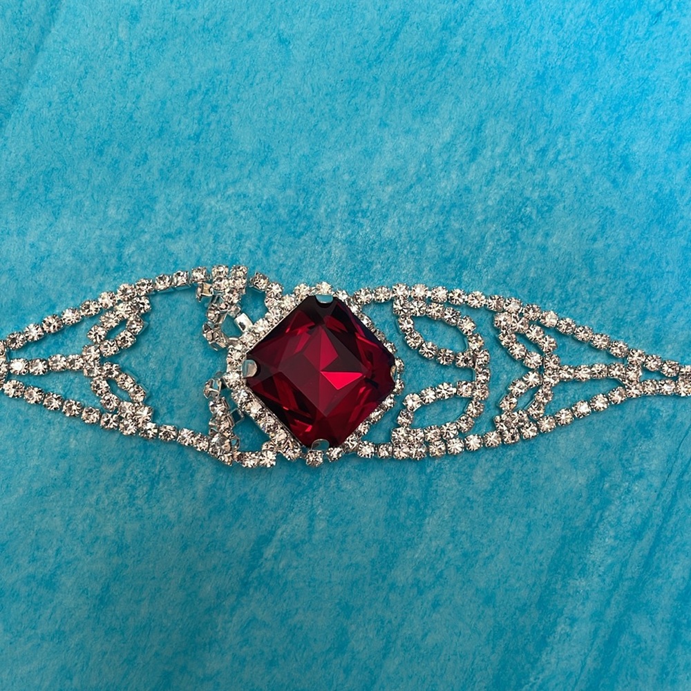 Gorgeous bracelet approx 1 inch red stone surrounded by rows of clear crystals.